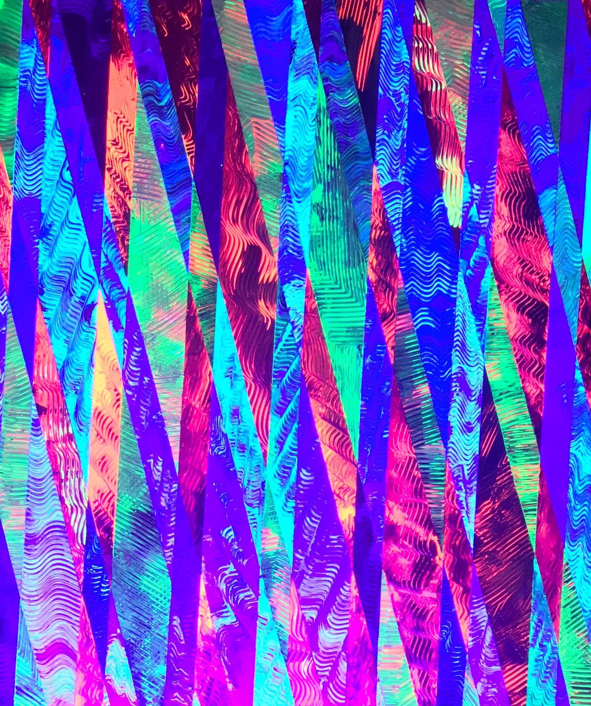 Metallic and fluorescent acrylics painting with colorful stripes, under UV light